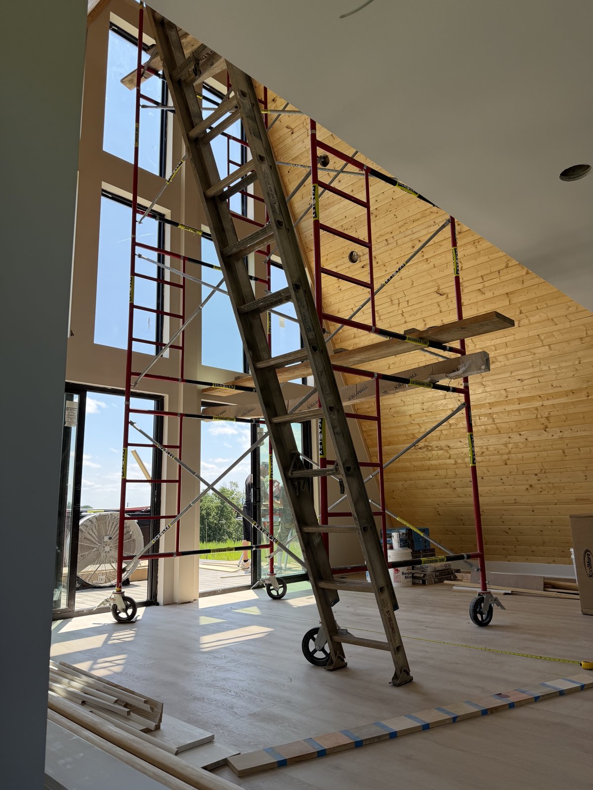 Wood-clad A-frame ceiling soaring above the great room windows