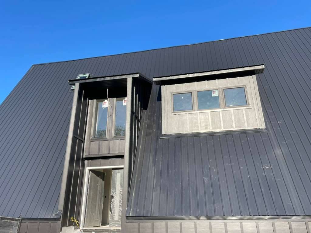 Dormers wrapped in dark siding
